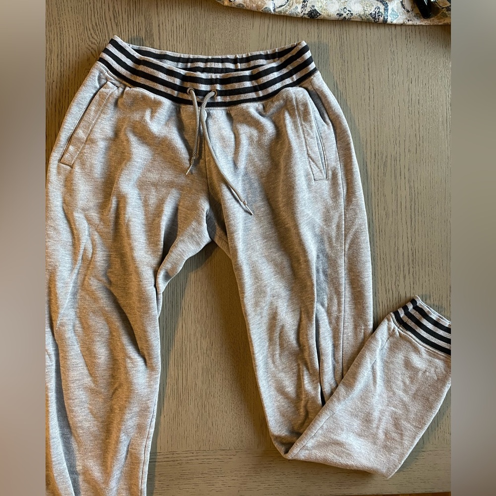 Grey tapered Adidas joggers with drawstring waist and pockets